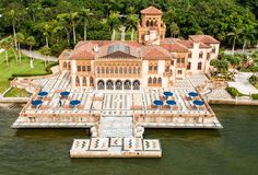 an aerial view of a mansion in the water