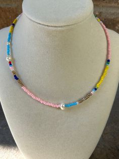 Multicolored seed bead necklace with shades of pink and blues. Accented with freshwater pearls. Pink Pearl Necklace With Tiny Beads, Adjustable Pink Pearl Necklace With Colorful Beads, Pink Beaded Bohemian Pearl Necklace, Pink Pearl Necklace With Colorful Round Beads, Pink Bohemian Beaded Pearl Necklace, Bohemian Pink Beaded Pearl Necklace, Bohemian Pearl Beaded Necklaces With Tiny Beads, Crystal Lake, Seed Bead Necklace