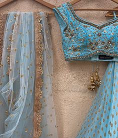 Sky Blue butti lehenga with a zari and pearl work border teamed with a matching raw silk zardosi and sequinned blouse with the most beautiful detailing. Completed with a matching soft net dupatta with sequins highlights and zari border. Composition: Lehenga- Georgette, Blouse : Raw Silk, Dupatta : Soft Net All products can be customised for sleeves, length of blouse and neck design Delivery : 2-4 weeks as the product is hand crafted. Check Size Guide or choose MySize for free customisation (All Sizes above XL can be made at 15% additional cost) For more information and sizes please contact fabiliciousfashion@gmail.com or visit our Copenhagen studio. About the Designer : Priti Sahni started out with a career on the well-trodden path by following typical Indian parent’s goal, to be a Compute Light Blue Lehenga, Indian Wedding Henna, Lengha Design, Wedding Fits, Raw Silk Blouse, Simple Lehenga, Powder Blue Color, Cotton Lehenga, Georgette Lehenga