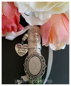 a close up of a key chain with flowers in the background