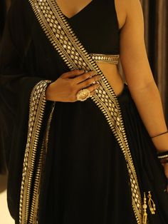 This black georgette lehenga choli set is the epitome of elegance and sophistication. Its detailed embroidery, sequin work, and heavy lace embellishments make it a standout choice for any special occasion.  The ability to customize the choli ensures a perfect fit, while the voluminous lehenga and intricately designed dupatta complete the ensemble, making it a perfect choice for those looking to make a lasting impression.
Complementing the lehenga is a matching choli that maintains the same Designer Black Anarkali Set With Cutdana, Black Anarkali Set With Cutdana For Designer Wear, Elegant Black Sharara With Gota Work, Festive Black Anarkali Set With Cutdana, Black Floor-length Anarkali Set With Cutdana, Designer Black Sharara With Gota Work, Black Anarkali Sharara With Cutdana, Black Saree With Sheer Dupatta For Reception, Black Sharara For Reception During Navratri