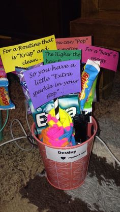 a bucket filled with candy and some notes