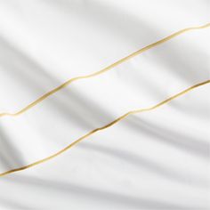 white and gold striped fabric with golden lines