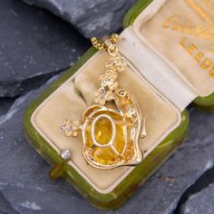 This intriguing citrine pendant features an oval checkerboard cut citrine being cradled by a woman in yellow gold and white gold flowers with diamond accents. The pendant is crafted in 14k gold. We have added an 18 inch long 14k yellow gold rounded box chain weighing approximately 3 grams. White Gold Flowers, Citrine Pendant, Round Box, Gold Flowers, Box Chain, Citrine, White Gold, Yellow Gold, Pendant Necklace