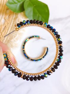 This stunning midnight beauty hoop earring are a beautiful accessory for any outfit. We love the beaded details of sparking black, navy blue, and aqua green. Depending on where the light hit will give a different color. Approximate length of earrings: 1.7/8" Materials have natural variations Colors may vary from different viewing device Also available other colors. Black Beaded Hoop Earrings For Party, Blue Hoop Earrings For Party, Black Small Hoop Jewelry For Parties, Black Small Hoop Earrings For Party, Green Hoop Earrings For Party, Green Hoop Jewelry For Party, Beaded Hoop Jewelry For Party, Trendy Turquoise Party Earrings, Party Beaded Hoop Jewelry