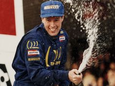 a man in blue uniform spraying water on his face