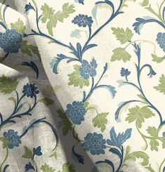 an upholstered fabric with blue and green flowers on white background, closeup