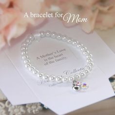 Keepsake gift bracelet for momWhite pearl beads and dainty heart charmFinished with iridescent beadBeautifully presented, boxed with sentiment A Mother's love is the heart of the familyHeirloom CollectionMade in the USA Mother's Day Gift Beaded Charm Bracelet, Elegant Pearl Bracelet With Heart Beads For Mother's Day, Silver Pearl Bracelet With Pearl Charm For Mother's Day, Mother's Day Jewelry With Pearl Charm And Round Beads, Heart Charm Bracelet For Wedding And Mother's Day, Mother's Day Gift Beaded Bracelet With Heart Charm, Adjustable Heart Bracelet For Wedding And Mother's Day, Heart Charm Bracelets For Wedding And Mother's Day, Mother's Day Beaded Bracelet With Heart Charm