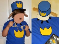 a child wearing a blue shirt and hat holding a pair of scissors in front of his face