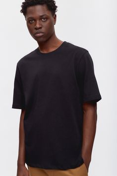 An everyday tee with an elevated feel, perfect for layering or wearing on its own. Made from our 100% Egyptian cotton mid-weight jersey for a more structured look and feel. Featuring a relaxed fit and dropped shoulder, which creates an easygoing drape. Black Essential T-shirt With Relaxed Fit, Basic T-shirt With Shirttail Hem For Layering, Black Relaxed Fit T-shirt, Casual Plain T-shirt For Layering, Boxy Fit Organic Cotton T-shirt With Crew Neck, Casual Boxy Fit T-shirt For Everyday, Relaxed Fit T-shirt With Straight Hem For Everyday, Relaxed Fit T-shirt For Everyday, Cotton T-shirt For Streetwear