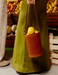 Campaign image of zola bag and fresh fruit Woven Leather Bag, Sustainable Leather, Leather Weaving, Leather Bucket Bag, Leather Bucket, Round Design, Isle Of Man, Beach Days, Classic Collection