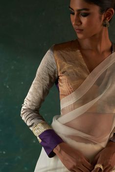 From festive to wedding, our gota sari that makes you stand out from the rest, paired with a multi tissue patchwork long sleeve blouse that adds a touch of glamour. This contemporary sari has the feel of the old world charm that is perfectly blending with the modern style. Gold tissue blazer over it not only gives a fusion contemporary touch but also keeps you warm yet glam. Designer Cotton Silk Blouse With Gota Work, Festive Cotton Silk Blouse With Gota Work, White Blouse With Sheer Dupatta For Diwali, Long Sleeve Pre-draped Saree With Zari Work, Transitional Party Cotton Silk Saree, Raw Silk Gota Work Blouse, Celebration Blouse With Sheer Dupatta In Traditional Drape, Blouse With Sheer Dupatta For Celebrations, Eid Cotton Silk Pre-draped Saree