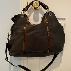 Never Worn! With Tags! In Great Condition. No Sign Of Wear Comes With Dust Bag Has Longer Strap That Is Removable Has Brown/Burnt Orange Stitching Detail Brown Top Handle Hobo Bag For On-the-go, Hobo Satchel With Handles, Brown Hobo Bag With Detachable Strap For On-the-go, Black Hobo Bag With Gunmetal Hardware And Top Handle, Brown Leather Top Handle Hobo Bag, Black Top Handle Hobo Bag With Gunmetal Hardware, Brown Leather-lined Top Handle Hobo Bag, Black Shoulder Bag With Leather Lining And Double Handle, Luxury Brown Shoulder Bag With Gunmetal Hardware