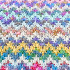 a multicolored crocheted blanket with stars on it