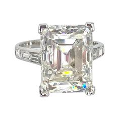 This stunning emerald cut diamond is set in a timeless vintage platinum setting. The center diamond is 7.07 carats, certified by GIA to be I color and VVS2 clarity, report number 2215810746. The delicate basket is embellished with ten tiny round single cut diamonds. There are three straight baguettes on the band, adding a subtle shine. The ring is finger size 4.75. Custom engraving and sizing available. Vintage Emerald Cut Diamond Engagement Ring, Engagement Ring With Baguette Band, Baguette Band, Baguette Engagement Ring, Emerald Cut Diamond Engagement Ring, Engraved Engagement Ring, Vintage Engagement Ring, Emerald Cut Diamond, Right Hand Rings