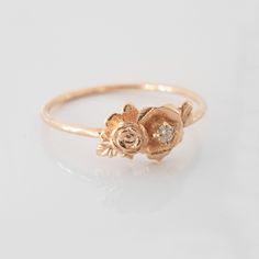 This mini rose flower ring is a beautiful little stacking ring that is like a little bouquet of gold roses and diamonds sitting on your finger. This ring is made in solid 14 karat gold with and set with a genuine VS-SI white diamond. Roses have long since represented love and romance, but are mainly known to represent God's love at work in the world. I made this ring as a reminder to us to always see the beauty and joy in the world. The simplicity of this ring stacks nicely with other rings and Dainty Gold Flower Ring For Wedding, Dainty Rose Design Flower Ring Gift, Delicate Gold Flower Ring With Rose Cut Diamonds, Luxury Dainty Yellow Gold Flower Ring, Dainty Yellow Gold Flower Ring, Gold Rose Ring, Diamond Ring Simple, Minimal Diamond Ring, Rose Flower Ring