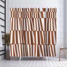 an orange and white shower curtain in a bathroom