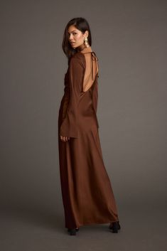 Neutrals never looked so good - say hello to the Strokes Mocha Long Sleeve Plunge Satin Maxi Dress. This sultry satin maxi features a plunging v-neckline with an adjustable-front tie, bell sleeves and open back. Sophisticated, elegant and subtly sexy, the Strokes Mocha Maxi Dress is trendy and timeless staple you can wear all year round. Brown Wedding Guest Dress, Brown Bridesmaid Dresses, Brown Maxi Dress, Long Sleeve Bridesmaid Dress, Brown Maxi Dresses, Fall Sweater Dress, Dresses Date Night, Concert Dresses, Fall Wedding Guest Dress