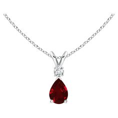 This classic solitaire pendant features a pear-shaped ruby secured in a prong setting. A brilliant round diamond sits atop the purplish red gemstone. Simple yet alluring, this ruby pendant in 14k yellow gold is crafted with a lustrous v-bale.
Ruby - Heat treated for enhanced clarity and brightness.Diamond - Not-treated.Diamond Information:Diamond Color: GClarity: VSShape: RoundCreation Method: NaturalTotal Diamond Weight: 0.105Total Number of Diamond: 1 Ruby Pendant, American Modern, Red Gemstones, Teardrop Pendant, Solitaire Pendant, Color Rojo, Pear Shaped, Round Diamond, Prong Setting