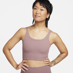 Feel calm and confident in this ribbed, scoop-neck bra. A longline silhouette gives you enhanced coverage while the non-padded, light-support design gives you a gentle hold with plenty of freedom. Lightweight, ribbed InfinaSoft fabric offers an irresistible softness that you can feel with every bend, stretch and shift—so you can stay comfortable from morning to night. Nike Stretch Crop Top For Sports, Nike Athleisure Crop Top For Gym, Nike Stretch Sports Crop Top, Nike Yoga Top With Built-in Bra, Nike Stretch Athleisure Crop Top, Nike Compressive Tops For Yoga, Nike Seamless Sports Bra For Athleisure, Nike Seamless Sports Bra For Yoga, Sporty Ribbed Scoop Neck Sports Bra