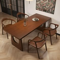 a dining table with four chairs around it