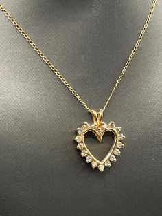 A beautiful ladies classic Diamond heart pendant designed and crafted in 14 karat solid yellow gold.  Set with 18 round dazzling white Diamonds framing the heart.  This one really sparkles and looks fabulous on your favorite chain! TDW: 1.00cts Weight:  3.7 grams Length:  1" Width: ¾" Our Price $595.00 Regularly Priced At $900.00 Please See Our Video Remember - If you're purchasing for yourself or a gift for a loved one, buy with confidence.  We Guarantee Everything We Sell!  SKU # P643 Formal Heart Necklace With Prong Setting For Valentine's Day, Classic Yellow Gold Heart Necklace With Diamond Accents, Classic Gold Diamond Necklace With Heart Charm, Yellow Gold Heart Pendant With Prong Setting, Yellow Gold Heart Pendant Jewelry With Prong Setting, Dazzling Gold Heart Cut Necklace, Classic Yellow Gold Diamond Necklace With Heart Charm, Classic Gold Heart Cut Diamond Necklace, Gold Heart-shaped Brilliant Cut Diamond Necklace