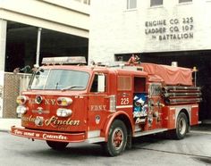 an old fire truck parked in front of a building