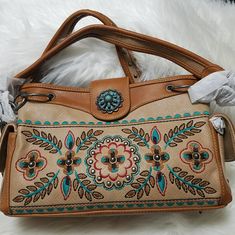 Montana West Embroidered Flower Satchel/Purse Made Of Pu Leather, This Satchel Has: Floral Embroidered Patternsilver Turquoise Stone On The Flap With Magnetic Button Closureaccented With Antique Silver And Crystal Studstop Zipper Closureinside Single Compartment Divided By A Medium Zippered Pocketinside Of Bag Include A Zippered Pocket And 2 Open Pockets A Pocket On Each Side That Snap Closea Zippered And An Open Pocket On The Back Double Flat/Chain Handle 13.5" X 5" X 8" (Drop 10") Embroidered Cream Shoulder Bag, Cute Christmas Pajamas, Flower Purses, Embroidered Handbag, Western Purses, Satchel Purse, Christmas Pajamas, Embroidered Flowers, Turquoise Stone