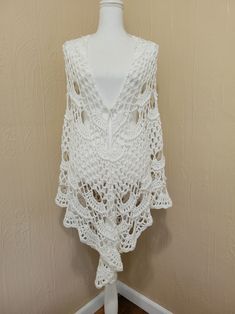 "Stunning handmade crochet shawl made with soft acrylic yarn. A wonderful addition to your wardrobe. It'll dress up any outfit and keep you warm during cool summer nights. It is about 90\" (2m 28cm) at the longest side and 42\"(1m 7cm) top to the bottom. Materials: premium acrylic, viscose, nylon. Care Instructions: Hand Wash recommended. Wash in warm water with mild soap. Rinse. Do not twist. Wrap in a towel to remove excess water. Spread on a dry towel or bed sheet to air dry. Available in oth Bohemian Crochet Cotton Top, Bohemian Crochet Lace Top In Cotton Yarn, One Size Crochet Lace Top For Beach, Bohemian Crochet Top In Knitted Yarn, Bohemian Crochet Lace Cotton Top, Handmade Knit Crochet Top For Beach, White Hand Knitted Crochet Top For Beach, Handmade Shawl For Beach In Spring, Crochet Shawl For Summer