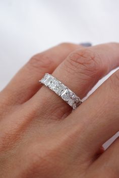 a woman's hand with a diamond ring on it