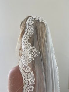 the back of a woman's head wearing a wedding veil