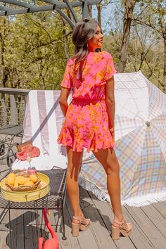 You are guaranteed to look sassy and sweet in this darling hot pink romper featuring lightweight material patterned with a pretty orange floral print, a faux wrap bodice with a v-cut neckline, short loose sleeves, a cinched elastic waistline with a tie closure, a keyhole accented upper back with a button closure, and a relaxed shorts silhouette that ends in straight upper-thigh length hemlines! on products Measurements XS : Bust 30", Hip 32", Inseam 2", Length 30", Sleeve Length 7", Waist 28". S : Bust 32", Hip 34", Inseam 2", Length 31", Sleeve Length 7", Waist 30". M : Bust 34", Hip 36", Inseam 2", Length 32", Sleeve Length 7.5", Waist 32". L : Bust 36", Hip 38", Inseam 2", Length 33", Sleeve Length 7.5", Waist 34". XL : Bust 38", Hip 40", Inseam 2.5", Length 34", Sleeve Length 8", Waist Hot Pink Romper, Pretty Orange, Orange Floral Print, Pink Romper, Pink Rompers, Loose Sleeves, Sweet Floral, Floral Romper, V Cuts