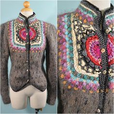 "Vintage 70s/80s artisan hand knit, crochet, embroidered sweater. Large puff/leg o mutton sleeves. Beautiful mother of pearl buttons. The sweater is fitted at the waist, buttons up the front, high neckline. There are many different materials, and elements in this piece, including shiny threads & beads. This is a very unique piece. LABEL: Monte Rosa, Made in Korea SIZE: Refer to measurements for an accurate fit. All sizes are approximate. Shoulder: 15\" Underarm: 32\" Sleeve: 24\" Waist: 29\" Fitted Vintage Multicolor Sweater, Vintage Hand Knitted Multicolor Sweater, Vintage Multicolor Hand-knitted Sweater, Fitted Knitted Bohemian Sweater, Vintage Multicolor Hand Knitted Sweater, Fitted Bohemian Knitted Sweater, Bohemian Fitted Knit Sweater, Vintage Fitted Hand Knitted Sweater, Fitted Vintage Hand Knitted Sweater