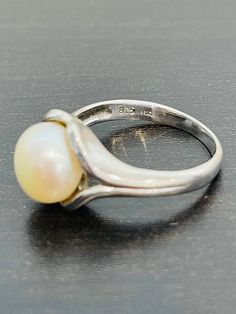 This is a classic and timeless look.  Pearls have become en vogue again and this is a ring that would appeal to most women.  Great for work or everyday.  This ring is made in sterling silver and is a size 8.  This pearl is 10 mm. Classic White Dome Ring For Wedding, Classic Sterling Silver Ring, Timeless Silver Sterling Silver Pearl Ring, Timeless Silver Pearl Ring With Polished Finish, Classic Silver Pearl Ring With Polished Finish, Timeless Silver Pearl Ring In Sterling Silver, Timeless Sterling Silver Pearl Ring In Silver, Classic Sterling Silver Dome Promise Ring, Timeless Pearl Ring In White Gold Sterling Silver