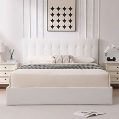 a white bed sitting in the middle of a bedroom next to a dresser and lamp