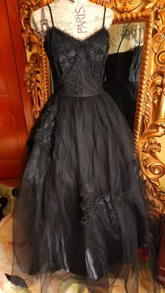 "This gorgeous formal gown is from the 50s by Emma Domb.  Rare solid black.  The underdress is made up of a black shiny acetate. There are two layers of tulle.  The under layer is a coarse tulle to give it its shape.  The outer layer is a finer tulle.  On the bodice and on the skirt are large lace bow appliques. The bodice is boned for structure. Side metal zipper.  There is one repair on the satin underdress near the hem where it looks like the original owners high heel might have gone through. You can't see this  when wearing the dress.  The hem of the tulle in some places has been trimmed (shown) This also does not show because of the fullness and the double layer of tulle.  This is a gorgeous gown and perfect for any formal event or Prom.  It was photographed with an extra petitcoat (n Evening Ball Gown With Tulle Skirt, Black Tulle Ball Gown For Evening, Black Tulle Ball Gown For Formal Events, Black Tulle Ball Gown For Formal Occasions, Formal Black Tulle Ball Gown, Vintage Black Gown For Wedding, Vintage Black Wedding Gown, Gothic Ball Gown For Evening, Vintage Evening Ball Gown With Fitted Bodice