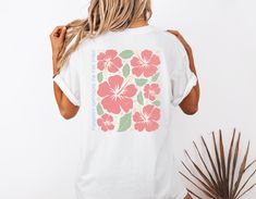 Step into summer with this charming Hibiscus Flower Beach T-Shirt! Designed to evoke tropical vibes and laid-back beach days, this tee features a vibrant hibiscus flower print that will instantly uplift your wardrobe. Made from soft and breathable fabric, this t-shirt is perfect for both lounging by the beach or casual outings with friends. Add a touch of island paradise to your style with this must-have summer essential! 🖤 Comfort Colors introduces the "Comfort Colors 1717" garment-dyed t-shir White Hibiscus Print T-shirt For Spring, White Tropical Hawaiian Shirt With Graphic Print, White Tropical Camp Shirt With Palm Tree Print, Pink Tropical T-shirt For Summer, White Tropical Printed Camp Shirt, Summer Printed Camp Shirt, Summer Camp Shirt For Vacation, White Tropical Camp Shirt With Graphic Print, Pink Hawaiian Camp Shirt For Beach