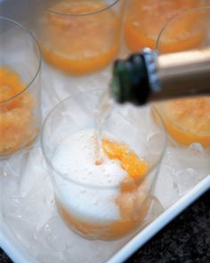 several glasses filled with orange juice and ice