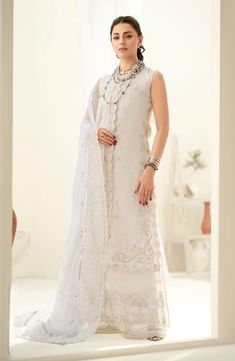 White Embroidered Pakistani Salwar Kameez with Dupatta is an elegant festive attire beautifully adorned with hand-worked details of threads and motifs. Punjabi Salwar Kameez, Pakistani Boutique, Organza Shirt, Punjabi Salwar, Indian Salwar Kameez, Pakistani Salwar, Indian Salwar, Readymade Saree, Lawn Dress