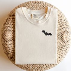 Add a touch of eerie elegance to your Halloween wardrobe with our exquisite Embroidered Bat Halloween T-Shirt. Crafted with attention to detail and a hint of spookiness, this shirt is the perfect blend of style and Halloween spirit. Whether you're heading to a costume party or just want to show off your festive side, this t-shirt is a must-have addition to your collection. Product Details: Design: A stunningly detailed bat embroidery that captures the mystique of the night. The intricate stitching brings out the bat's intricate wings and features, creating a captivating visual. Material: Premium quality cotton ensures comfort and durability, making this t-shirt perfect for extended wear throughout the Halloween season and beyond. Fit: A relaxed and comfortable fit suitable for all body typ Halloween Embroidered Long Sleeve T-shirt, Halloween Long Sleeve Embroidered T-shirt, Embroidered Long Sleeve T-shirt For Halloween, Halloween Embroidered Cotton Tops, Halloween Embroidered Crew Neck T-shirt, Halloween Cotton Embroidered Tops, Embroidered Cotton Tops For Halloween, Bat Top, Bat Embroidery