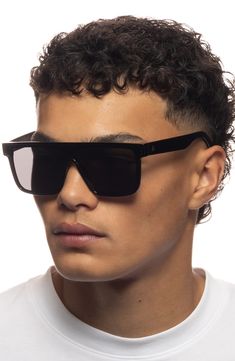 Add these bold shield sunglasses to your everyday look for some serious modern style that keeps the sun's rays at bay with full-coverage UV protection. 142mm lens width; 17mm bridge width; 144mm temple length   100% UV protection   Recycled polycarbonate   Imported Wayfarer Sunglasses With Uv Protection For Streetwear, Modern Shield Sunglasses For Beach, Modern Polarized Shield Sunglasses For The Beach, Modern Shield Sunglasses With Polarized Lenses For Beach, Modern Polarized Shield Sunglasses For Beach, Anti-reflective Wayfarer Sunglasses For Streetwear, Modern Wayfarer Shield Sunglasses For Beach, Modern Shield Sunglasses With Uv Protection For Beach, Matte Black Shield Sunglasses With Uva Protection For Streetwear