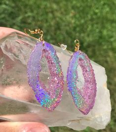 These pink holographic color shifting geode earrings are sure to get compliments or make an amazing one of a kind gift! They are mostly a clear  pink at a certain angle and then as soon as they shift they show a beautiful sparkly rainbow. They are lightweight-made with resin to ensure this- and won't bother your ears. Please choose whether you would like gold or silver earwires Clip on earrings are available as well For those who want all the sparkle but in a smaller geode stud, these are also a Iridescent Pierced Drop Earrings, Iridescent Party Earrings, Iridescent Pierced Jewelry For Party, Pierced Iridescent Jewelry For Party, Party Jewelry With Iridescent Ear Wire, Unique Iridescent Earrings For Party, Handmade Iridescent Crystal Earrings For Party, Nickel-free Iridescent Crystal Earrings For Party, Purple Glitter Jewelry Gift