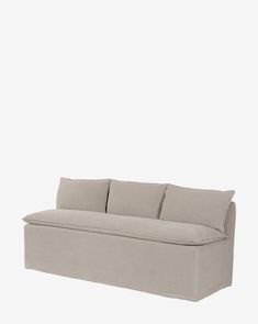 a gray couch sitting on top of a white floor