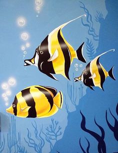 two black and yellow fish swimming in the ocean