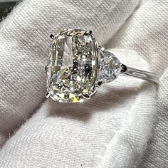 an oval diamond ring with three pear shaped diamonds