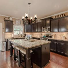 a large kitchen with an island in the middle and lots of counter space around it