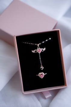 Discover the elegance and romance of our Heart's Desire Jewelry Set! This stunning set includes a delicate necklace and a matching ring, both showcasing exquisite heart-shaped pink gemstones surrounded by brilliant clear stones. The necklace features a lovely winged design on either side of the pendant, symbolizing freedom and beauty, and a little dangling heart for added charm. The ring echoes this design, with a striking heart-shaped pink gemstone embraced by sparkling clear stones. ✨ **Unique Valentine Necklaces Jewelry, Brahms Heelshire, Tangled Jewelry, Valentines Day Necklace, Goodnight Kiss, Enchanting Jewelry, Valentine Gifts Jewelry, Ring Gift Box, Single Father