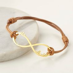 "** LEATHER INFINITY BRACELET WITH NAMES** A perfect gift for moms that personalized with her kids' names P R O D U C T ∙ I N F O * Material: Solid 925 Sterling Silver, Coated leather * Finishing: Silver - Yellow Gold - Rose Gold * Dimensions: 1 3/4\" (42mm) x 1/2\" (12.7mm) * Character limits: up to 10 characters per name for best visibility * All the letter will be lower letters for the best look of this design. H O W ∙ T O ∙ O R D E R * Choose your finishing color and the number of names. * S Everyday Heart-shaped Name Bracelet For Mother's Day, Personalized Rose Gold Name Bracelet For Mother's Day, Hypoallergenic Heart-shaped Name Bracelet For Mother's Day, Adjustable Name Bracelet - Mother's Day Gift For Her, Personalized Name Bracelet - Gift For Mom, Necklace With Kids Names, Signet Rings Women, Moms Bracelet, Family Necklace