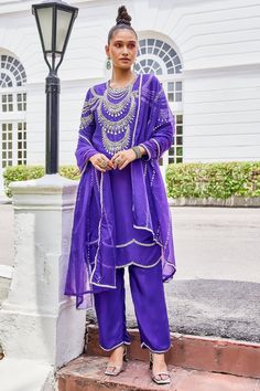 Poppy purple kurta intricately embellished with sequin, pearl, lace, and stone in silk base. Paired with a matching silk pant and dupatta.
Components: 3
Pattern: Embroidered
Type Of Work: Sequin, Pearl, Lace, Stone
Neckline: Round
Sleeve Type: Long
Fabric: Kurta and Pant: Silk, Dupatta: Organza
Color: Purple
Other Details: 
Model is wearing size M
Occasion: Mehendi and Haldi - Aza Fashions Purple Georgette Palazzo Set With Traditional Drape, Traditional Drape Purple Palazzo Set With Dabka Work, Traditional Drape Purple Georgette Palazzo Set, Purple Palazzo Set With Mirror Work For Festive Occasions, Festive Purple Palazzo Set With Zari Work, Elegant Purple Palazzo Set With Dupatta, Purple Georgette Palazzo Set, Purple Embroidered Palazzo Set For Festive Occasions, Embroidered Purple Palazzo Set For Festive Occasions