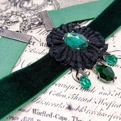 Dear customers, for a price offer of expedited shipping outside of Germany, please contact me directly via Etsy messages. A Gothic Victorian green choker, a romantic and elegant design with a black lace flower and a green Swarovski pendant with 3 green droplets, made to bloom with your gothic dress, special event or any romantic outfit. Goth fashion is distinguished by darkness, mystery, elegant wardrobe pieces and, smoky makeup even though it may surprise some that not all Goths always wear bla Elegant Adjustable Green Choker, Elegant Green Adjustable Choker, Adjustable Green Handmade Choker, Gothic Green Jewelry For Gifts, Green Gothic Jewelry For Gifts, Green Gothic Style Jewelry Gift, Green Gothic Jewelry Gift, Handmade Gothic Choker Gift, Handmade Gothic Choker For Gift